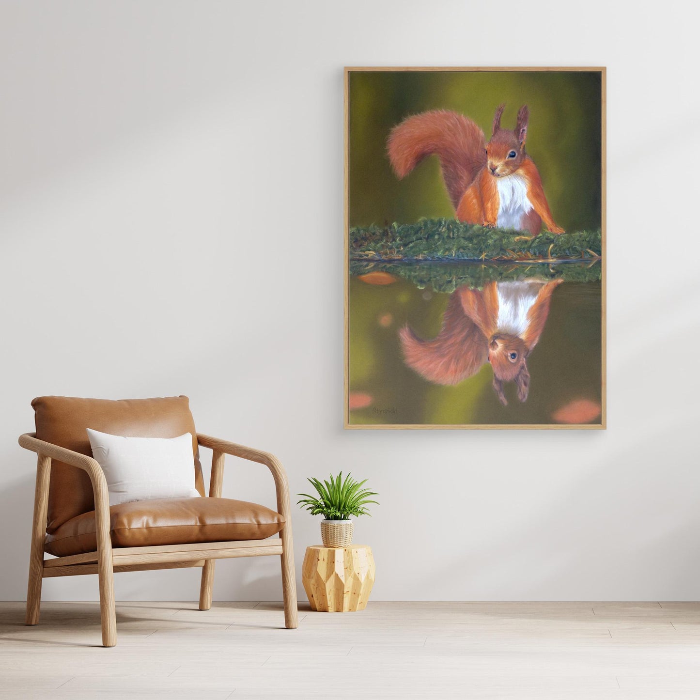 Framed canvas print of a red squirrel and reflection on a wall in a room