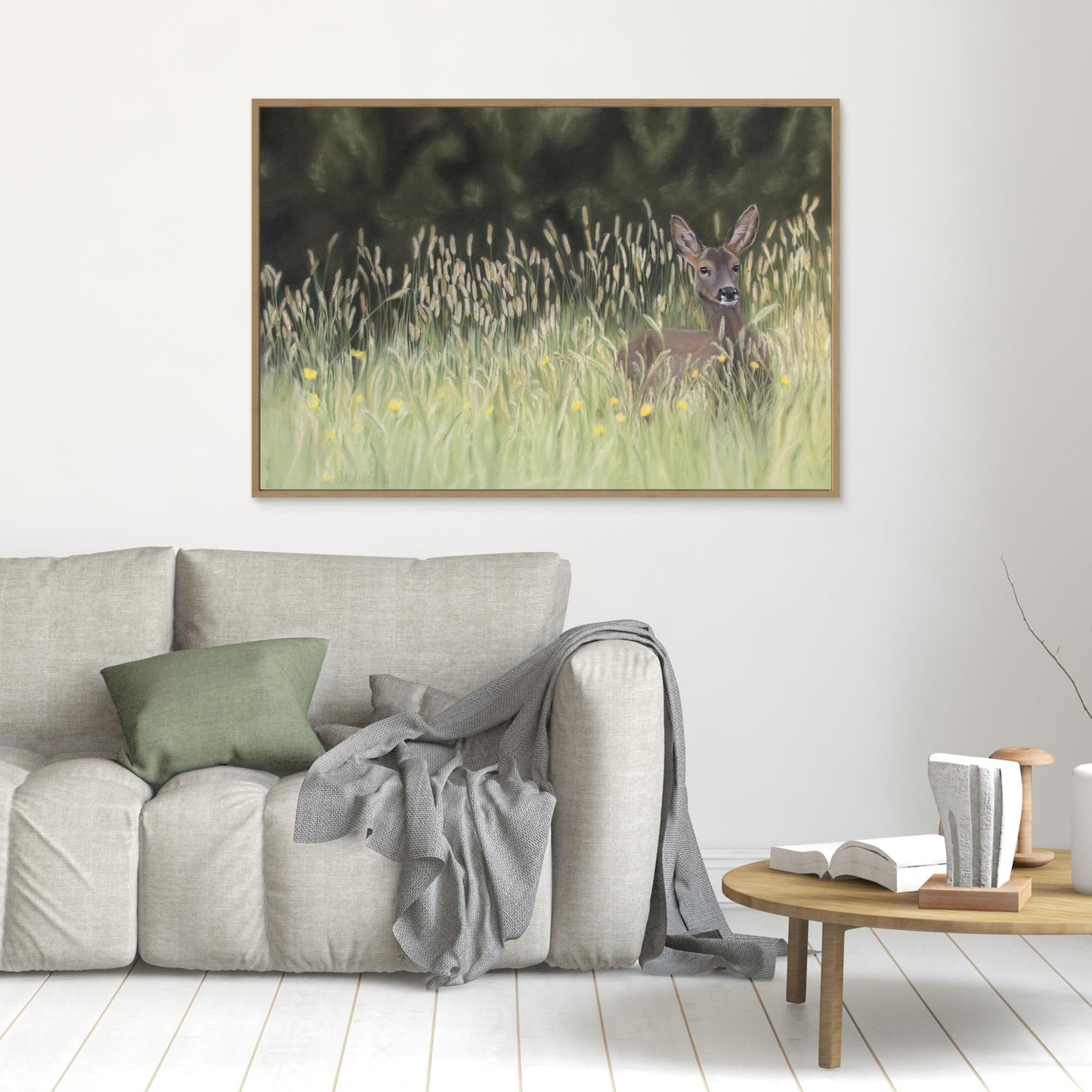 Canvas print of a wild deer in grassland on a wall with furniture in front