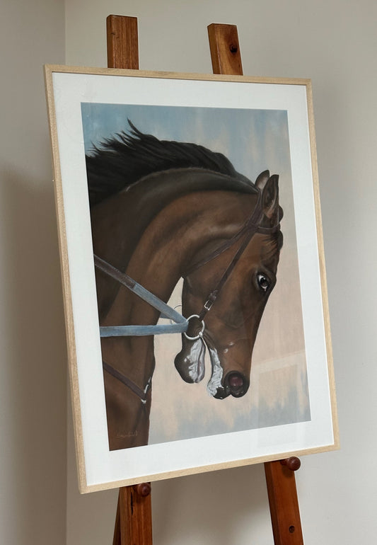 Framed painting of a horse on an easel against a plain wall