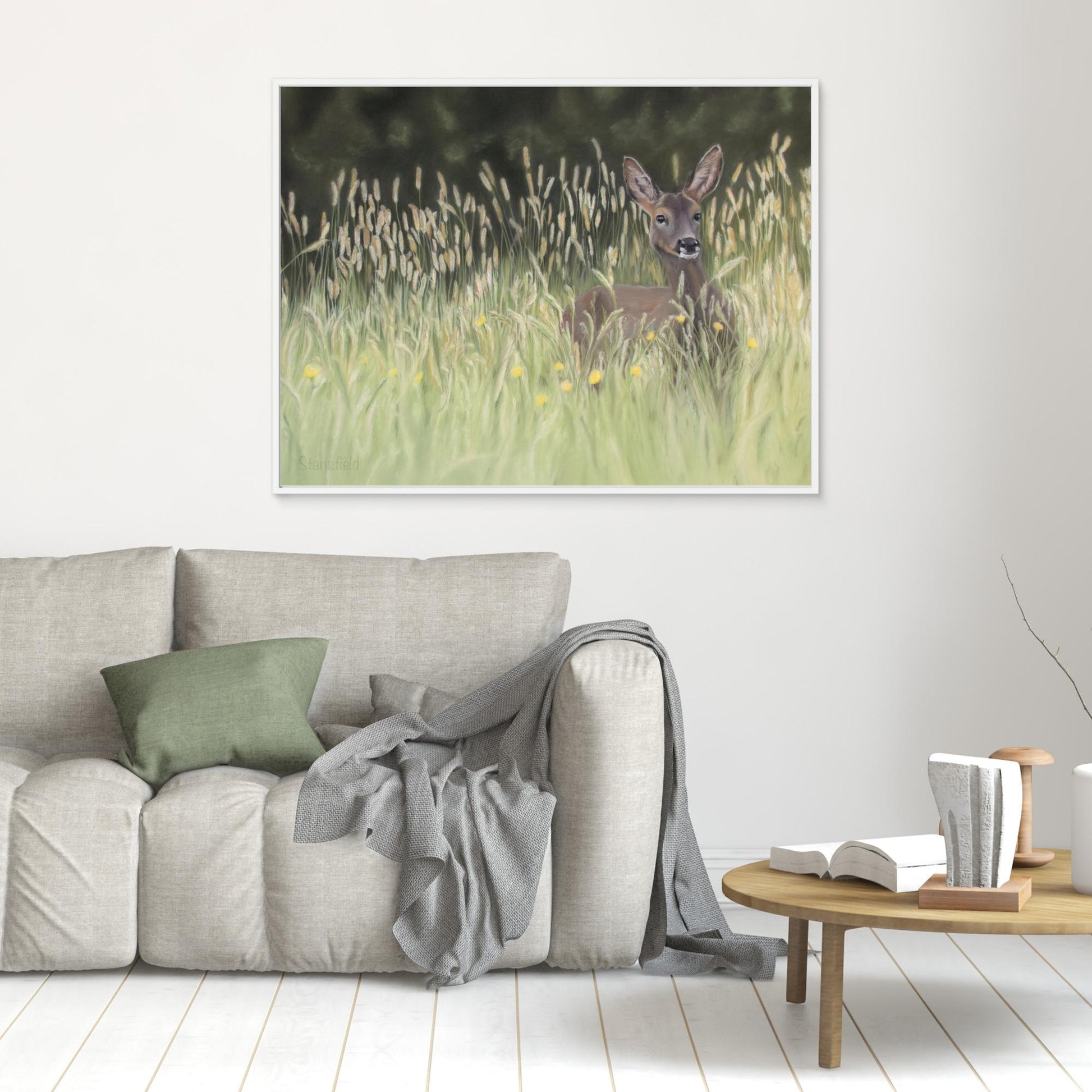 Framed stretched canvas of a print of a realistic wild deer painting in a room setting